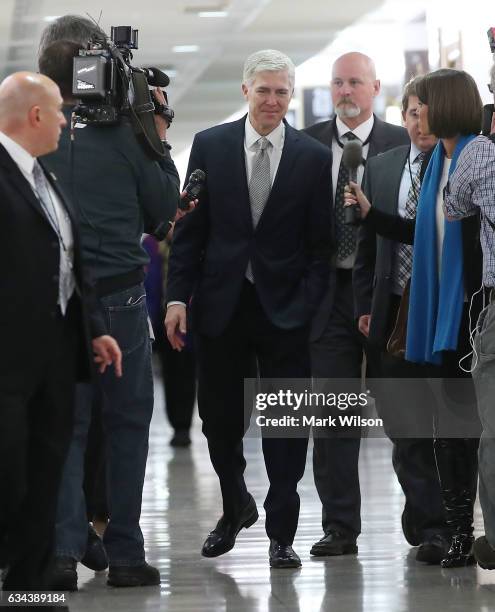 Supreme Court nominee Judge Neil Gorsuch , is approached by members of the media as he walks to a meeting with Sen. Susan Collins , on Capitol Hill...