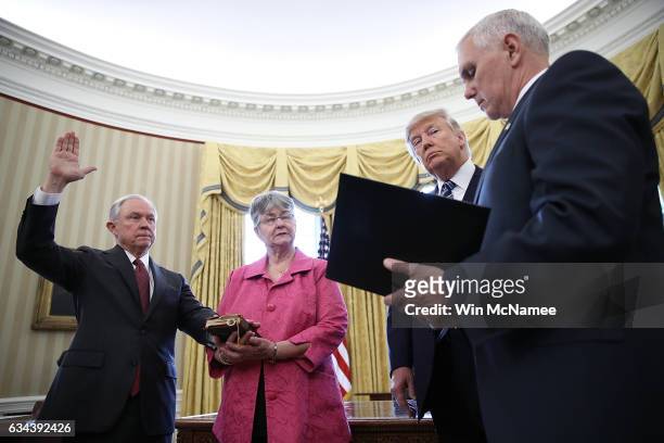 President Donald Trump watches as Jeff Sessions is sworn-in as the new U.S. Attorney General by U.S. Vice President Mike Pence in the Oval Office of...