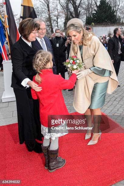 Queen Maxima of the Netherlands gets flowers from Magdalena Guenther watched by Reiner Haseloff, governor of Saxony-Anhalt and his wife Gabriele...