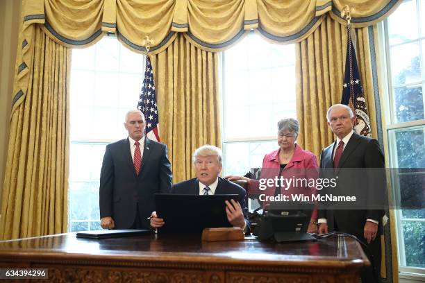 President Donald Trump reads from an executive order he signed in the Oval Office of the White House February 9, 2017 in Washington, DC. Prior to...