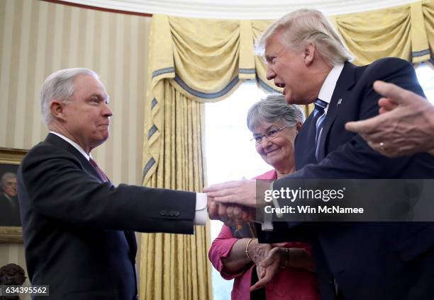 President Donald Trump shakes the hand of Jeff Sessions after Sessions was sworn in as the new U.S. Attorney General by U.S. Vice President Mike...