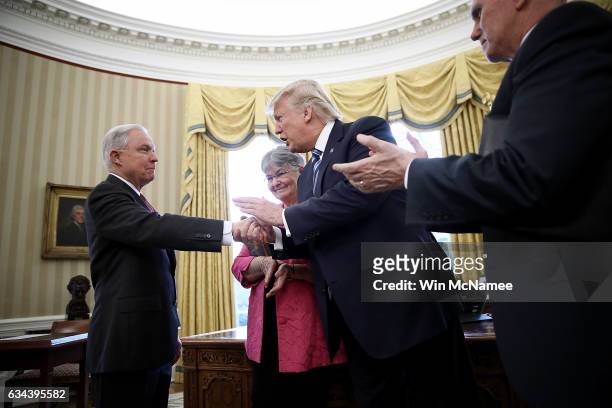 President Donald Trump shakes the hand of Jeff Sessions after Sessions was sworn in as the new U.S. Attorney General by U.S. Vice President Mike...