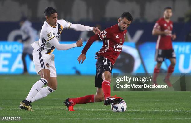 Jorge Alberto Ortiz of Club Tijuana plays the ball from Ariel Lassiter of the Los Angeles Galaxy during their friendly match at StubHub Center on...