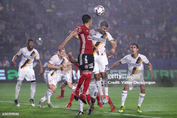 Josh Turnley of the Los Angeles Galaxy and Pablo Meza of Club Tijuana vie for the ball during the second half of their friendly match at StubHub...