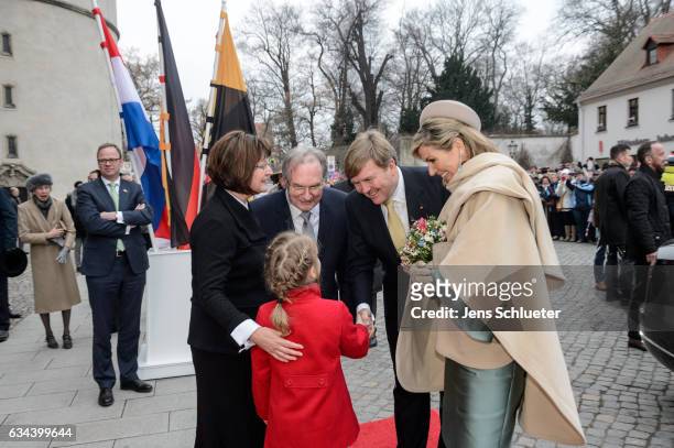 King Willem-Alexander shakes the hands with Magdalena Guenther watched by Queen Maxima of the Netherlands, Reiner Haseloff, governor of Saxony-Anhalt...