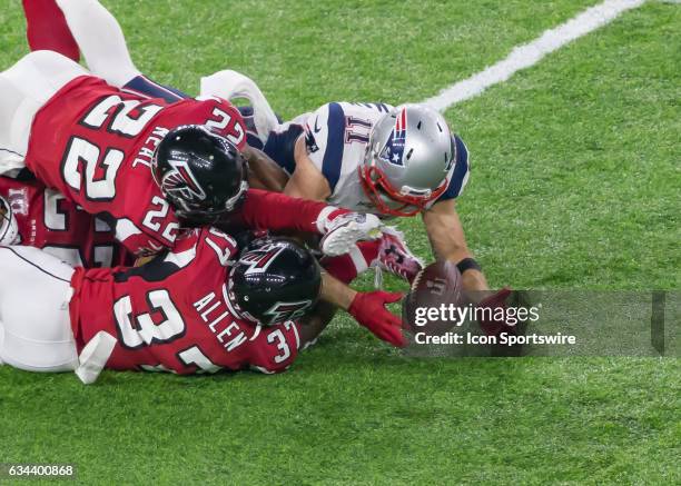 New England Patriots wide receiver Julian Edelman is tackled by Atlanta Falcons strong safety Keanu Neal and Atlanta Falcons free safety Ricardo...