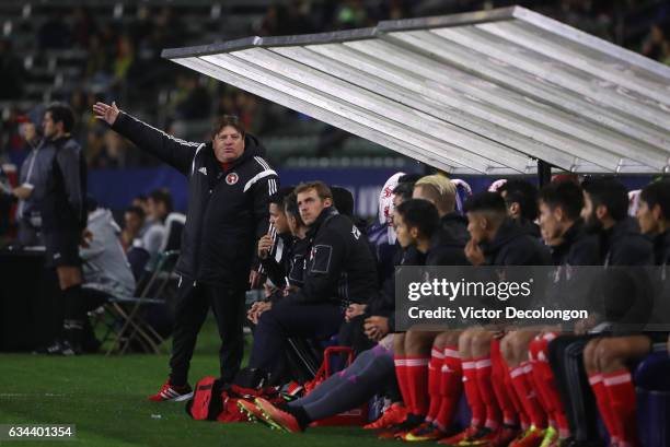 Head Coach Miguel Herrera of Club Tijuana talks to his players in the bench area during the friendly match against the Los Angeles Galaxy at StubHub...