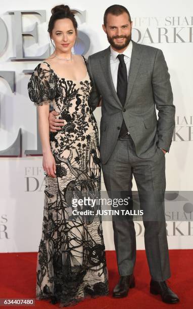 Actress Dakota Johnson and Northern Irish actor Jamie Dornan pose on the red carpet upon arrival at the UK premiere of Fifty Shades Darker in London...