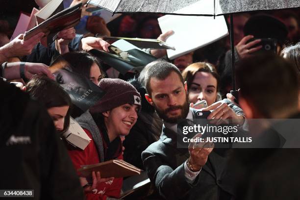 Northern Irish actor Jamie Dornan poses with fans on the red carpet upon arrival at the UK premiere of Fifty Shades Darker in London on February 9,...