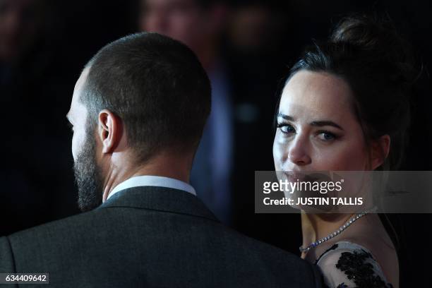 Actress Dakota Johnson poses with Northern Irish actor Jamie Dornan on the red carpet upon arrival at the UK premiere of Fifty Shades Darker in...