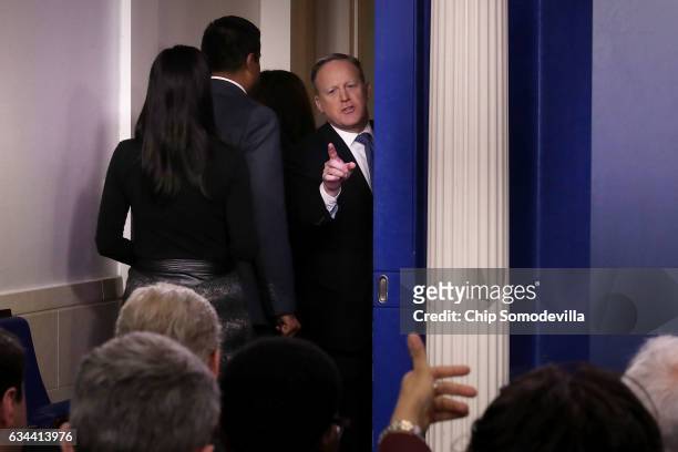 White House Press Secretary Sean Spicer turns to answer reporters' questions after leaving the Brady Press Briefing Room at the White House February...