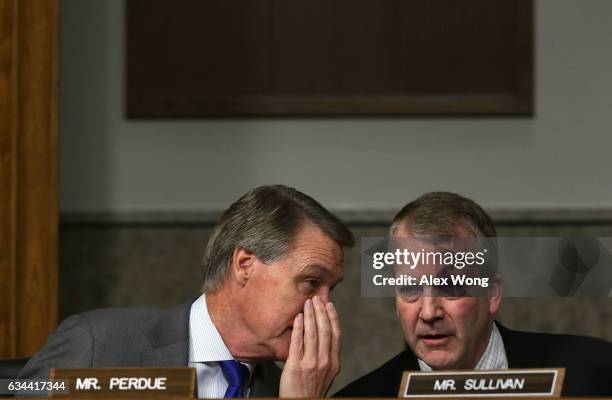 Sen. Daniel Sullivan listens to Sen. David Perdue during a hearing before Senate Armed Services Committee February 9, 2017 on Capitol Hill in...