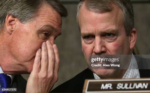 Sen. Daniel Sullivan listens to Sen. David Perdue during a hearing before Senate Armed Services Committee February 9, 2017 on Capitol Hill in...