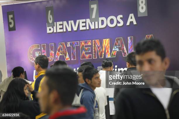 Sign reading "Welcome to Guatemala" greets deportees after they arrived on an ICE deportation flight on February 9, 2017 to Guatemala City,...