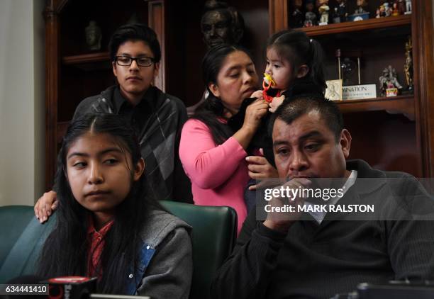 Immigrant Mario Vargas waits with his wife Lola and their daughter Athena in their attorney's office before the deportation hearing of Mario, in Los...