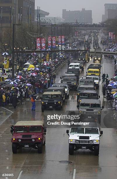 Super Bowl XXXV champions Baltimore Ravens, travel in Hummer's down Pratt Street along the Inner Harbor during their victory parade through the rain...