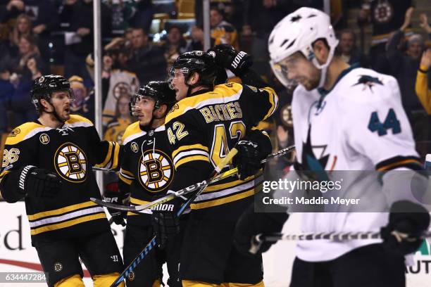 Patrice Bergeron of the Boston Bruins is congratulated by Kevan Miller, David Backes and Brad Marchand after scoring a goal as Marc-Edouard Vlasic of...