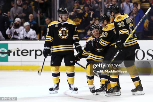 David Pastrnak of the Boston Bruins celebrates with Torey Krug, Patrice Bergeron and Brad Marchand after scoring against the San Jose Sharks during...