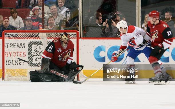Goalie Mike Smith of the Arizona Coyotes makes a save on the shot by Andrew Shaw of the Montreal Canadiens as Michael Stone of the Coyotes defends...