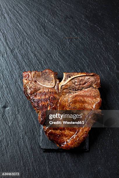 roasted porterhouse steak on black - grilled steak stock pictures, royalty-free photos & images