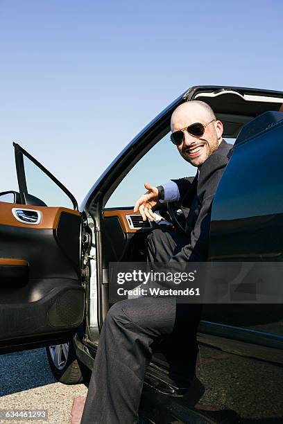 businessman with sunglasses smiling sitting in a convertible car - best sunglasses for bald men fotografías e imágenes de stock