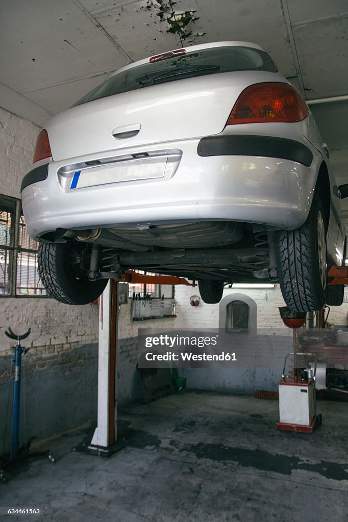 Car on hoist in a workshop