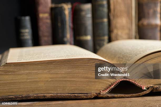 opened book in a historic library, close-up - passato foto e immagini stock