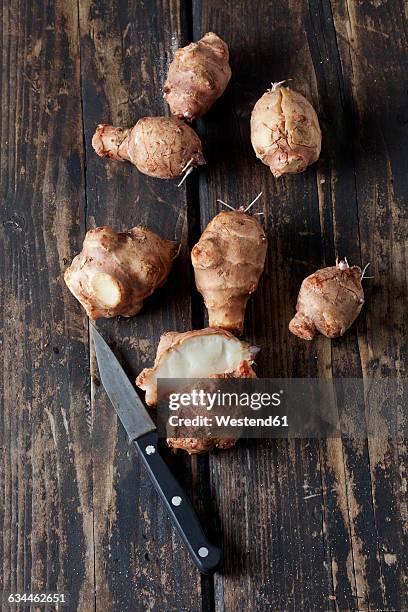 fresh topinambur on wood - jerusalem artichoke stock pictures, royalty-free photos & images