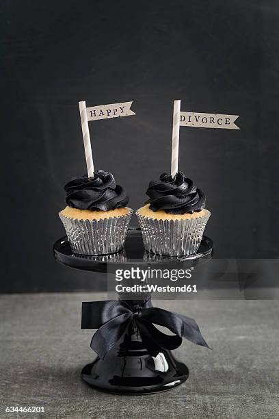 two cup cakes with black coloured buttercream topping and pennons on a cake stand - cake flag stock pictures, royalty-free photos & images