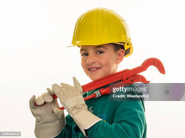 portrait of boy with hard hat holding large pliers - boy in hard hat photos et images de collection