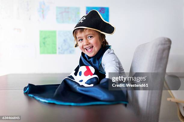 portrait of laughing little boy dressed up as a pirat - pirat stockfoto's en -beelden