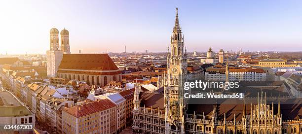 germany, bavaria, munich, church of our lady and new town hall at marienplatz, panorama - marienplatz stock-fotos und bilder
