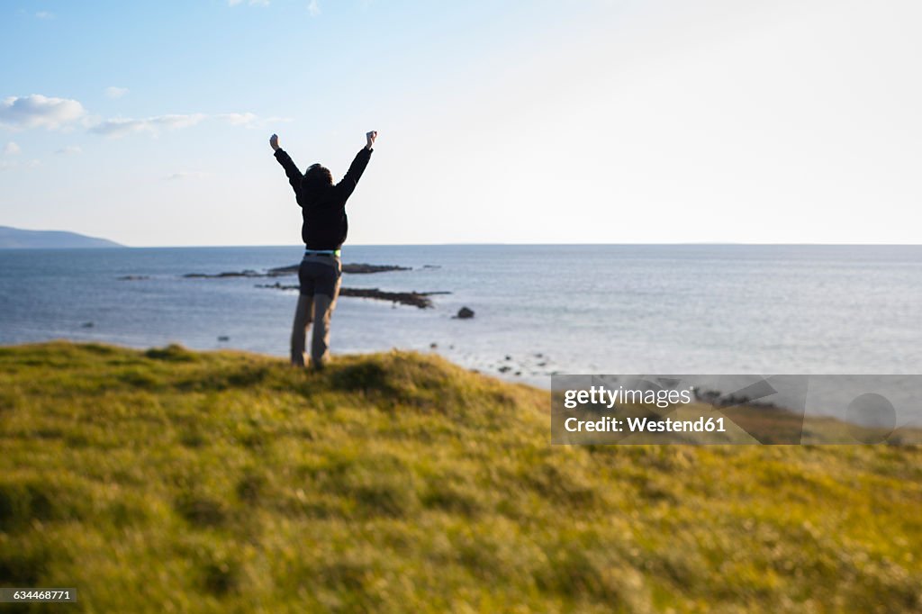 Ireland, Man enjoying the wind in Connemara