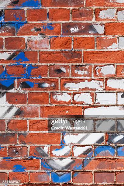 old brick wall with remains of graffiti - graffiti on brick wall stock-fotos und bilder