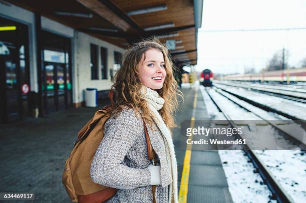 smiling teenage girl on station platform - passengers 2016 film stock-fotos und bilder