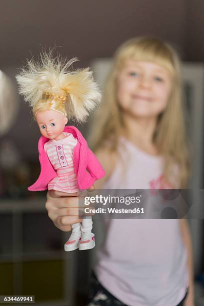little girl showing doll - showcase dolls stock pictures, royalty-free photos & images