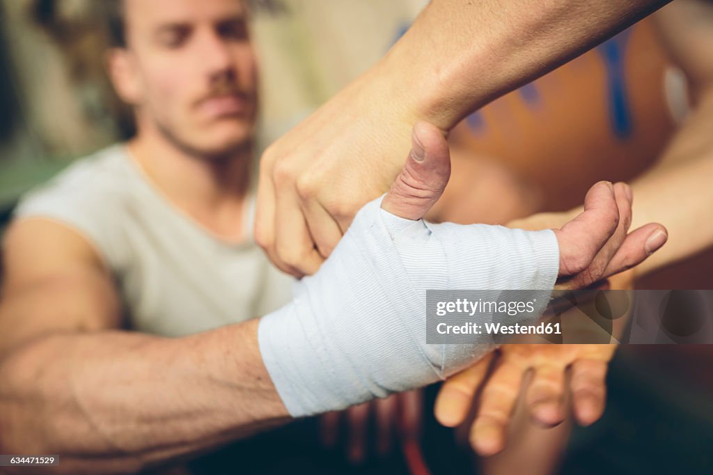 Boxer's hand is being bandaged