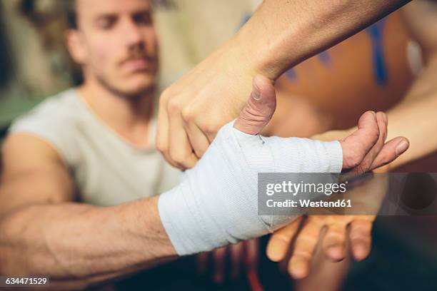 boxer's hand is being bandaged - boxing coach stock pictures, royalty-free photos & images