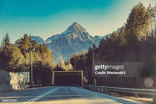 germany, bavaria, tunnel and speed limit sign in front of zugspitze mountain - zugspitze stock pictures, royalty-free photos & images