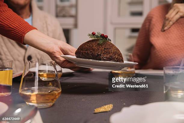 close-up of christmas pudding being put on table - christmas pudding stockfoto's en -beelden