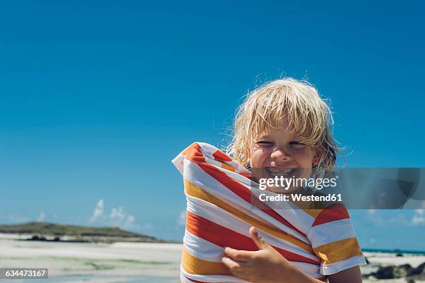 france, brittany, happy boy on the beach - gap france stock-fotos und bilder