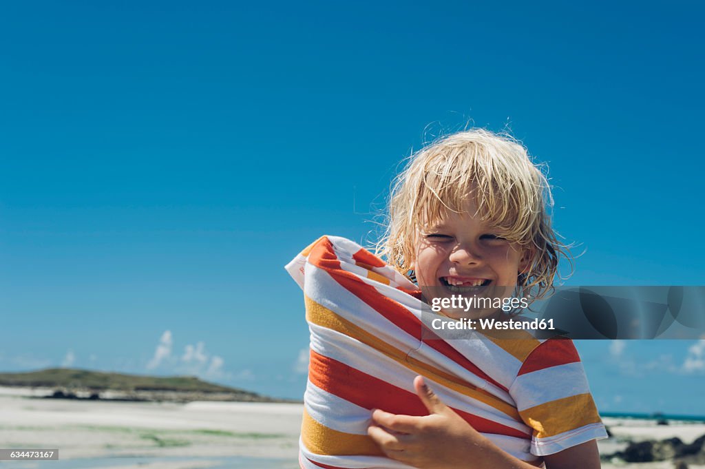 France, Brittany, happy boy on the beach