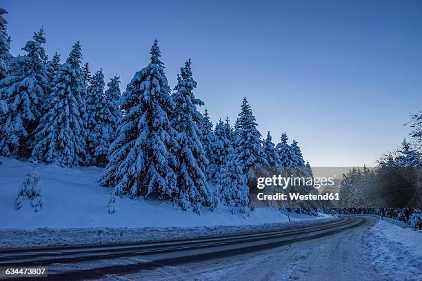 germany, lower saxony, harz national park, mountain road in the evening - snow road stock-fotos und bilder