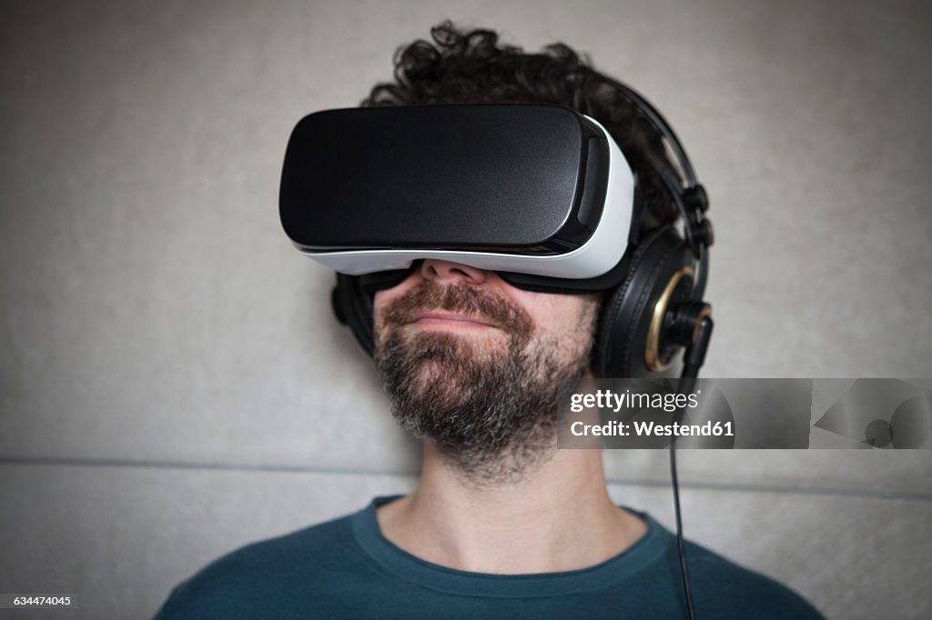 Man wearing Virtual Reality Glasses and headphones