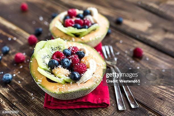 half of a melon filled with fruit salad - halved banana stock pictures, royalty-free photos & images