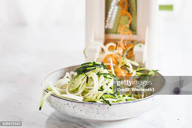 raw zucchini and carrot spaghetti cut with spiral slicer - spaghetti squash stock pictures, royalty-free photos & images