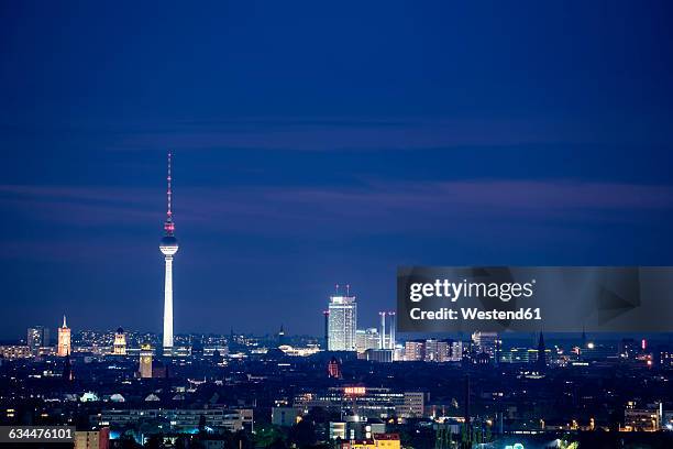 germany, berlin, view from rudow to lighted television tower at berlin-mitte - berlin fernsehturm stock pictures, royalty-free photos & images