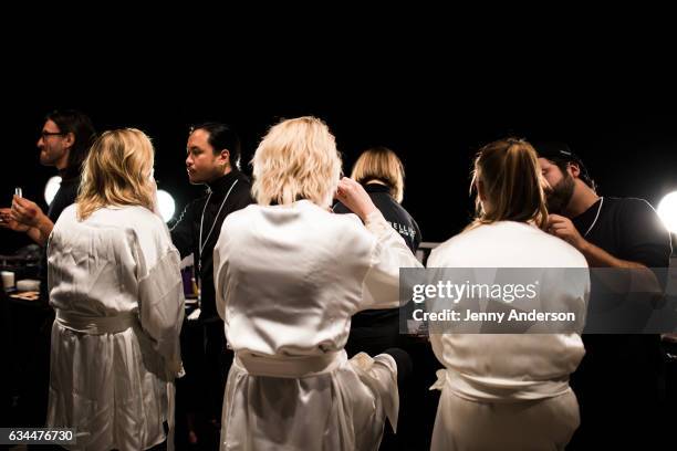 Models prepare backstage at the La Perla show during New York Fashion Week at SIR Stage 37 on February 9, 2017 in New York City.