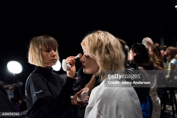 Model prepares backstage during the La Perla show during New York Fashion Week at SIR Stage 37 on February 9, 2017 in New York City.
