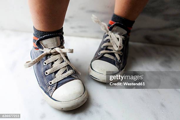 close-up of boy wearing sneakers - running shoes close up stock-fotos und bilder